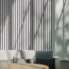 Wall with a white acoustic panel and a sofa