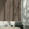a wall with vintage oak acoustic panels and a sofa